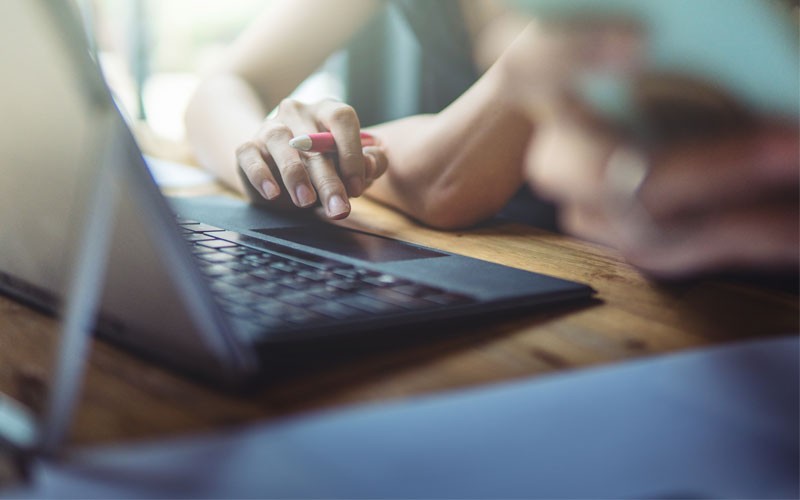 Securely access computers, files and applications in any location Close up of woman typing on keyboard