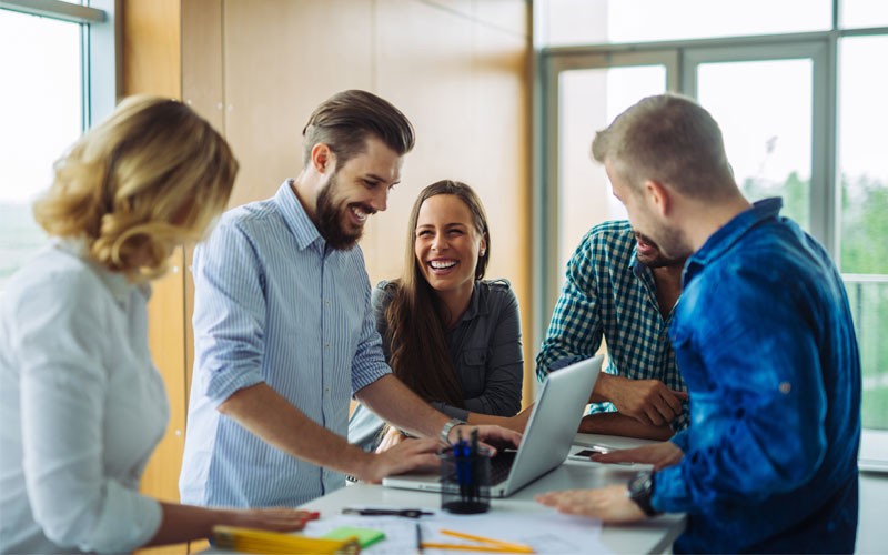 TechSmith software allows your organization to communicate and collaborate Collaboration of multiple employees surrounded by technology device