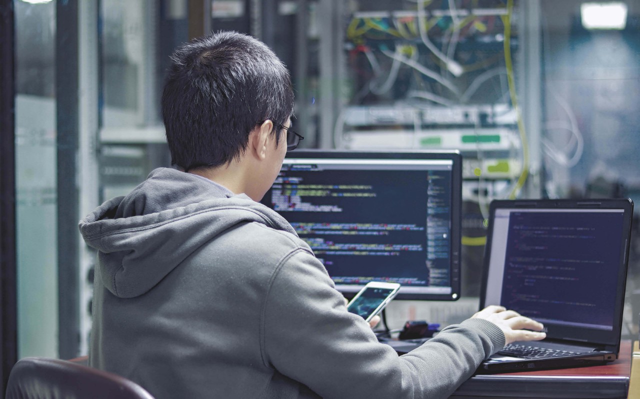 Protect every bit of your data. Man working in server room