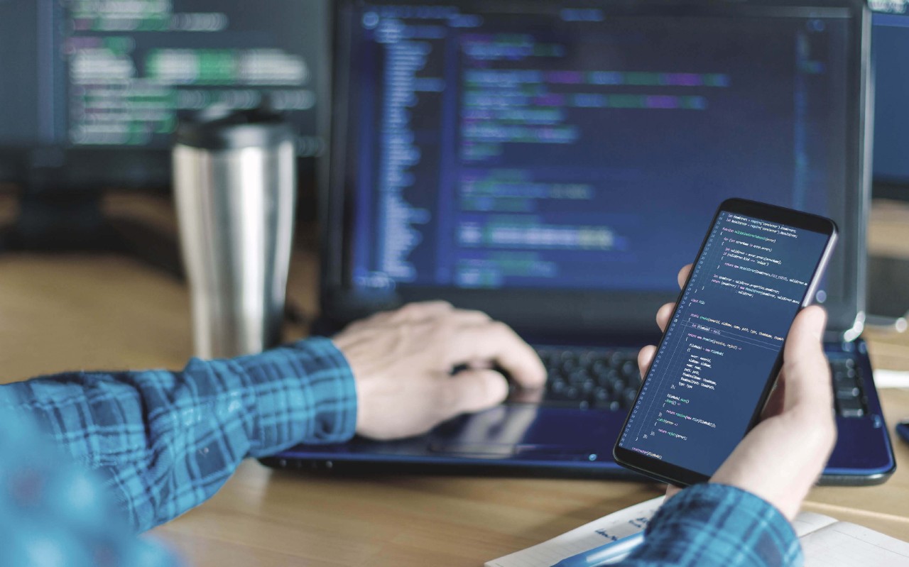 Digital compliance Man using his smartphone at work