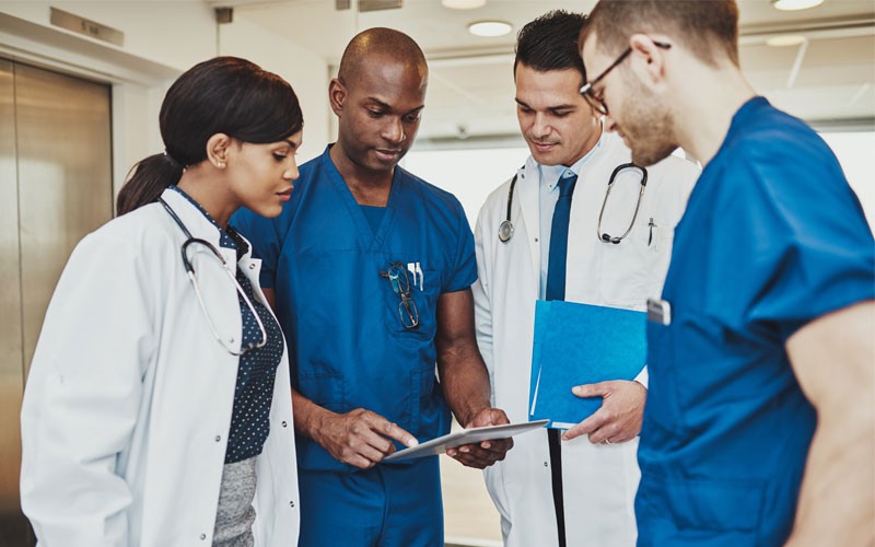 A modern workplace for modern healthcare Group of doctors looking over tablet