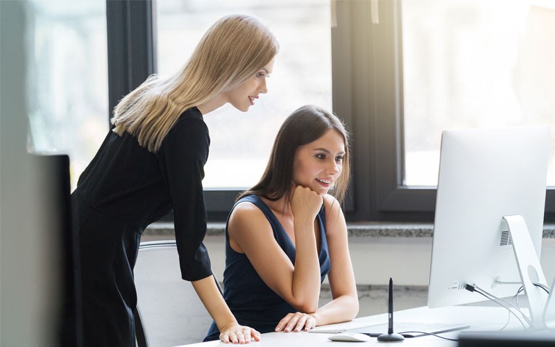 Government organizations can strive to control costs Two woman looking over monitor and desktop