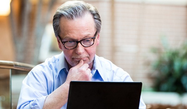 Pay-as-you-go pricing models Executive reviewing payment models off of his laptop computer