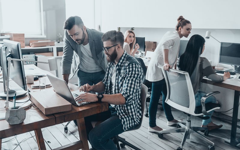 Virtualization solutions to power your business Open modern office with team members collaborating