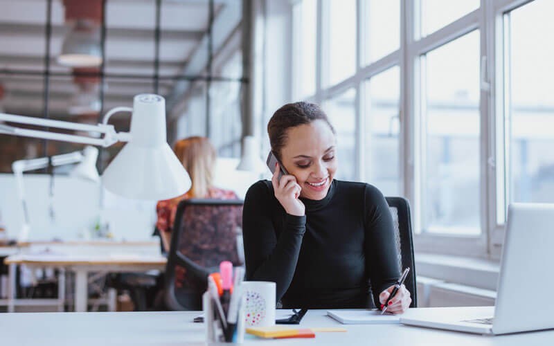 Vonage CX Cloud empowers you to deliver quality service Woman smiling on the phone