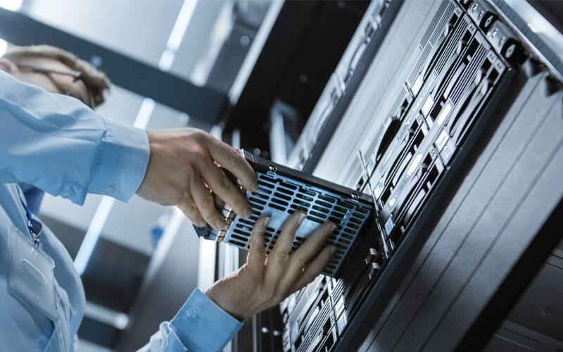 Internal hard drives for back up Business man inserting hard drive to data center