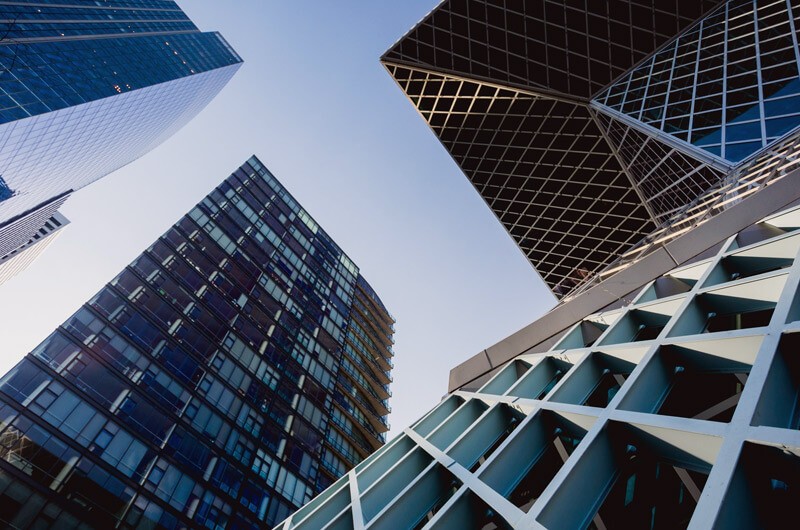 We help organizations like yours design and implement solutions that transform your business for the future Looking up at buildings