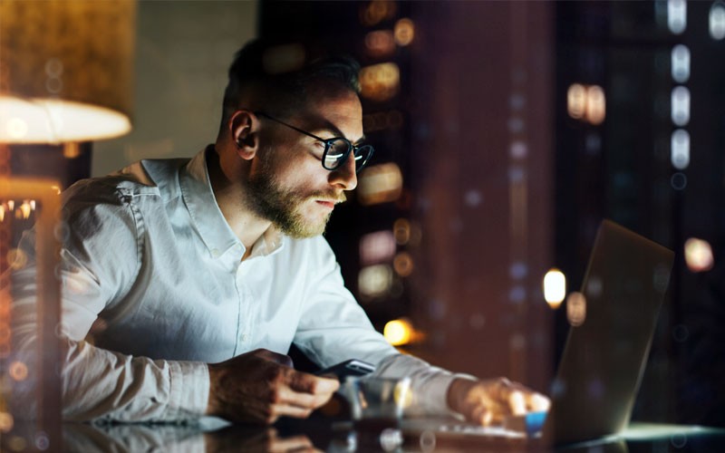 We’ll help secure your most valuable information IT professional using laptop in office at night
