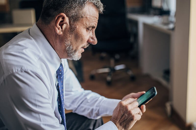 Government compliance and security solutions Close up of government official using smart phone