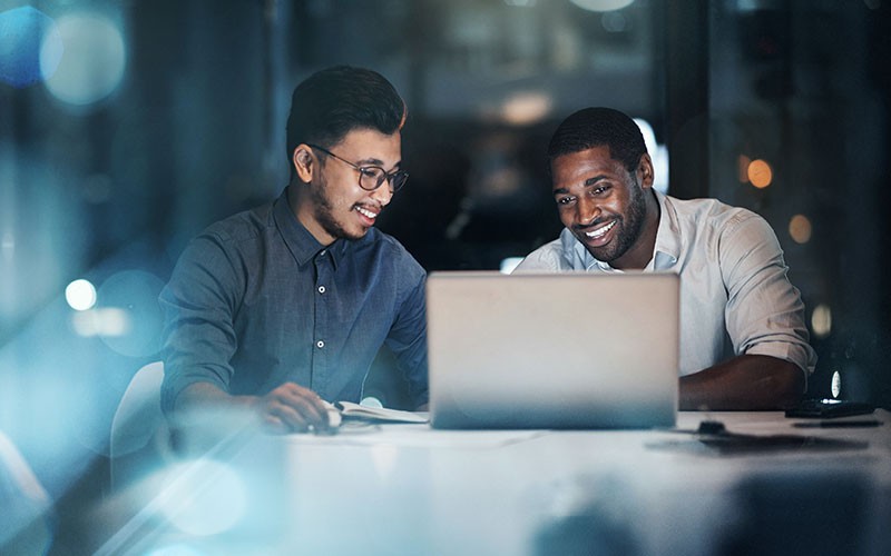 Unlock the power of people and technology Two business colleagues collaborating in workplace