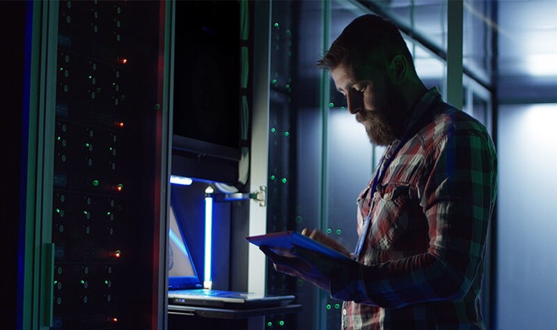 network-technician-in-modern-data-center Male in data center