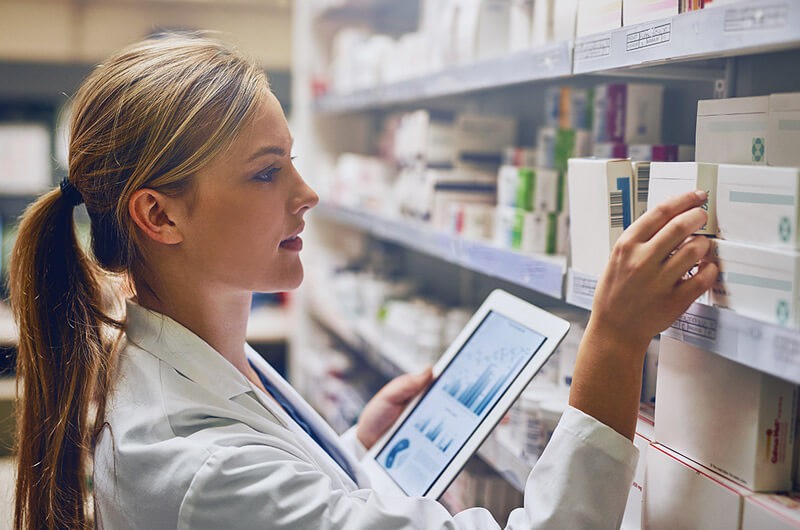 Pharmacist working with technology Pharmacist working with technology