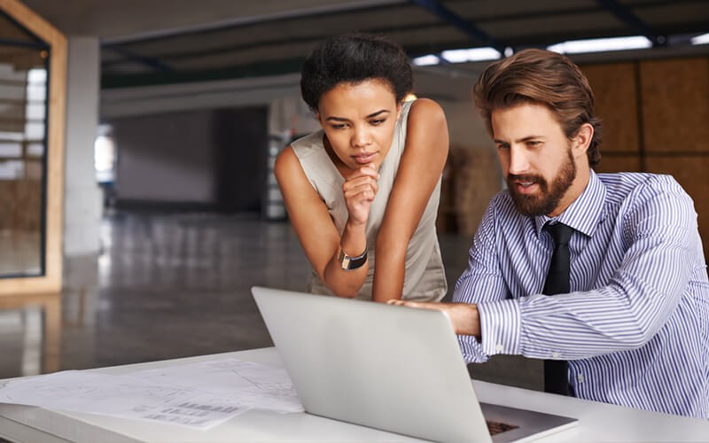 We handle every aspect of the deployment, from initial analysis to end-user support Two business professionals use deployment services on laptop computer