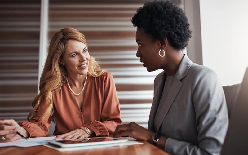 Our hosted licensing team provides reporting and administration services Executive businesswomen meet to discuss licensing options