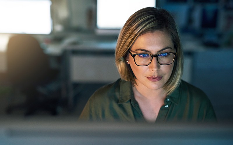 Our security assessment equips you with the information you need to implement enterprise-wide protection Businesswoman in glasses reviews security assessment on computer