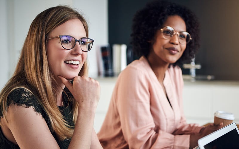 Smiling businesswomen discussing new skills and processes