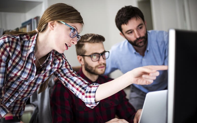 We’ll capture the right data from your environment Teammates reviewing software licenses on desktop computer