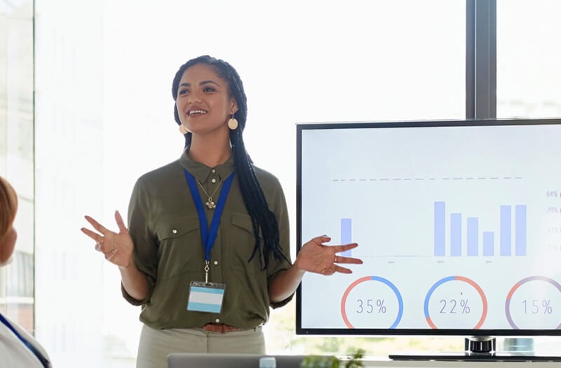 business-woman-presenting-infront-of-large-monitor business-woman-presenting-infront-of-large-monitor