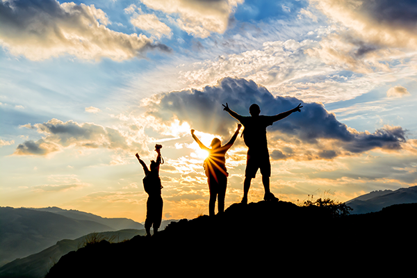 Together we can help your business do more Silhouette of hikers climb mountain at sunset