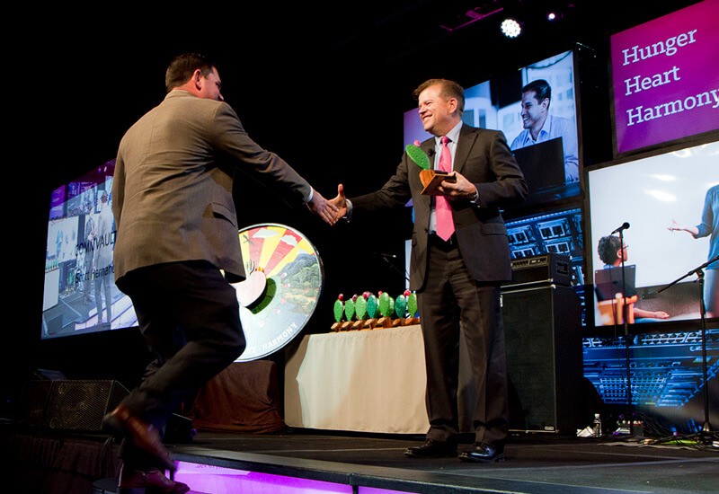 Our managers work with teammates to help them achieve their career goals Sales team member shakes hand with SVP Bob Kane