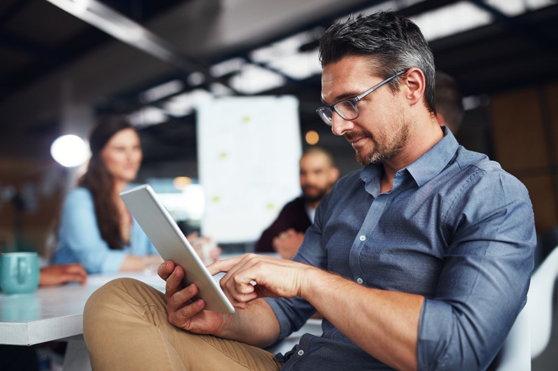 Employee holding tablet device