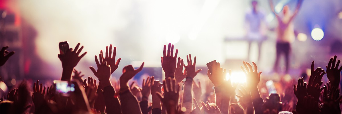 crowd raising hands