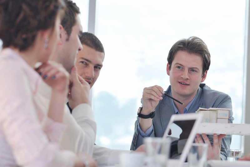 People having a business meeting with man holding a pen