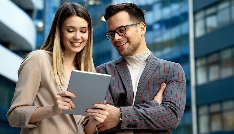 Woman and man looking at a tablet