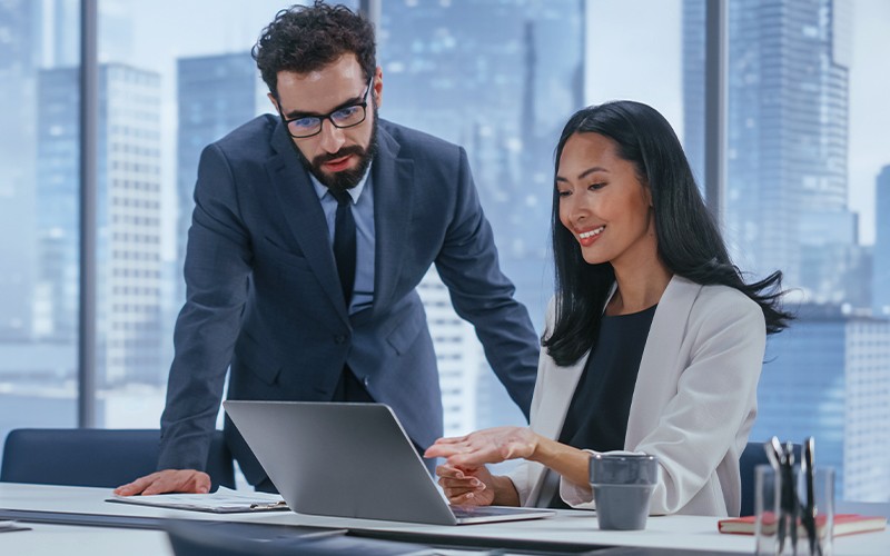 Man assisting female coworker