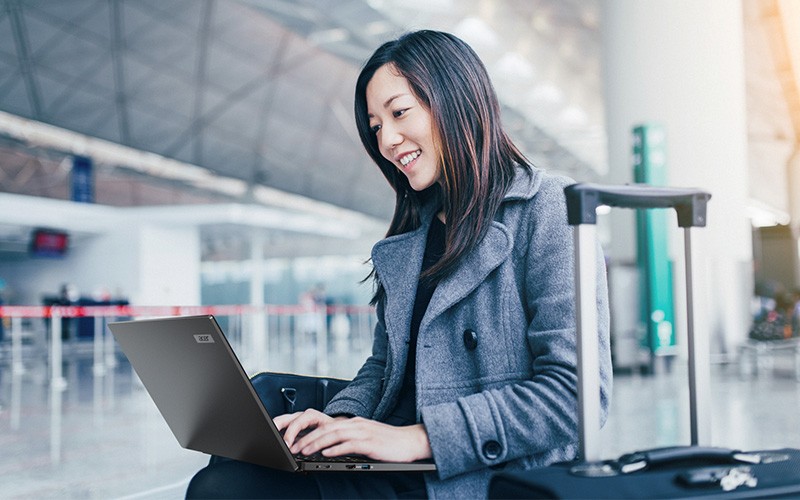 woman using laptop in airport