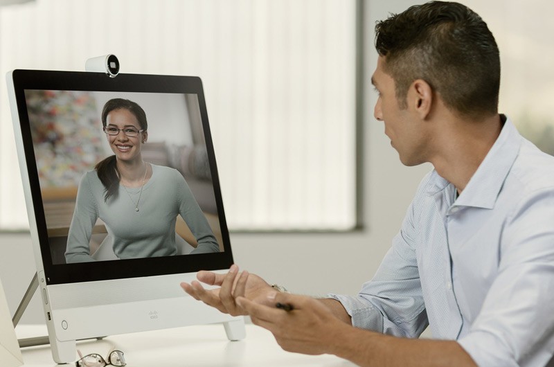 Collaboration Businessman sittling at his desk videoconferences with teammate.