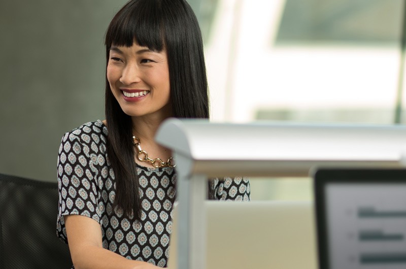 Security Attractive businesswoman smiling at her desk.