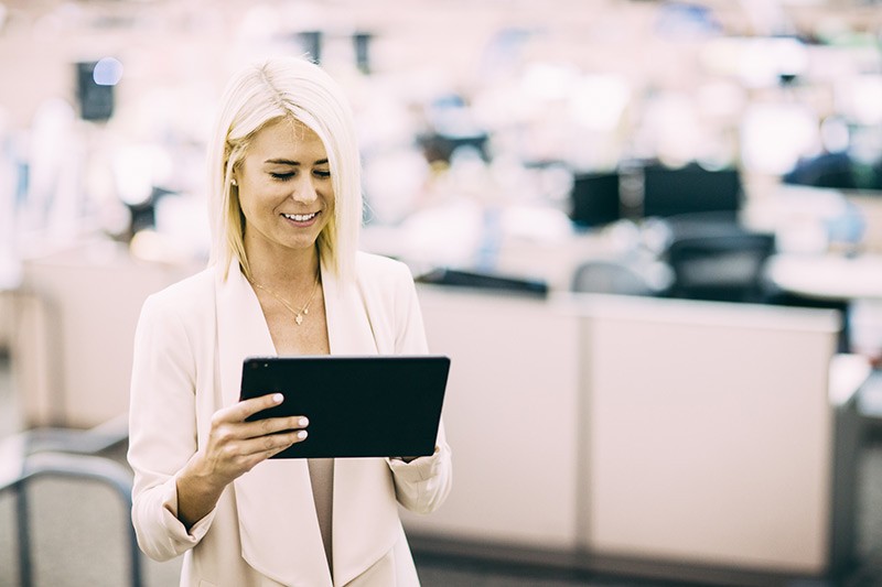 Managed devices automatically pull security policies and settings from the cloud Business woman using tablet computer