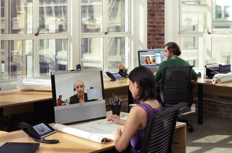 Programs designed for growth. Business professionals in modern office highrise with large windows.