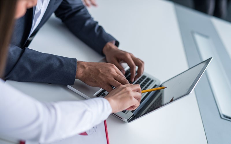 Secure esignature technology Employees pointing at laptop screen