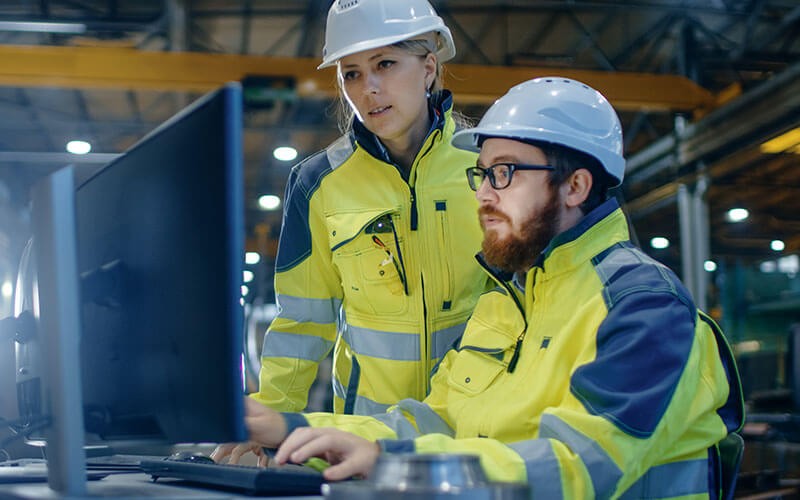 Power management solutions Two employees working on computer in warehouse