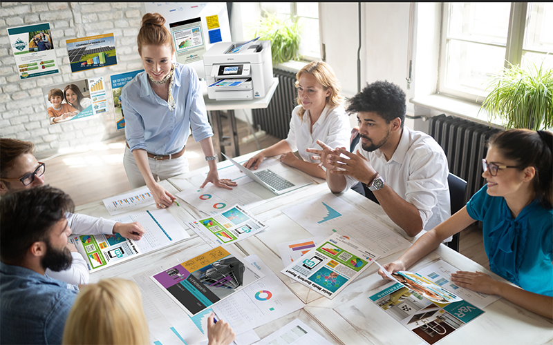 Male creative designer printing marketing material at Epson printer