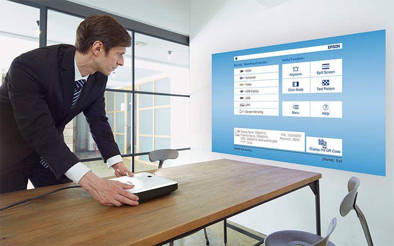 Woman working at standing table with Epson projector