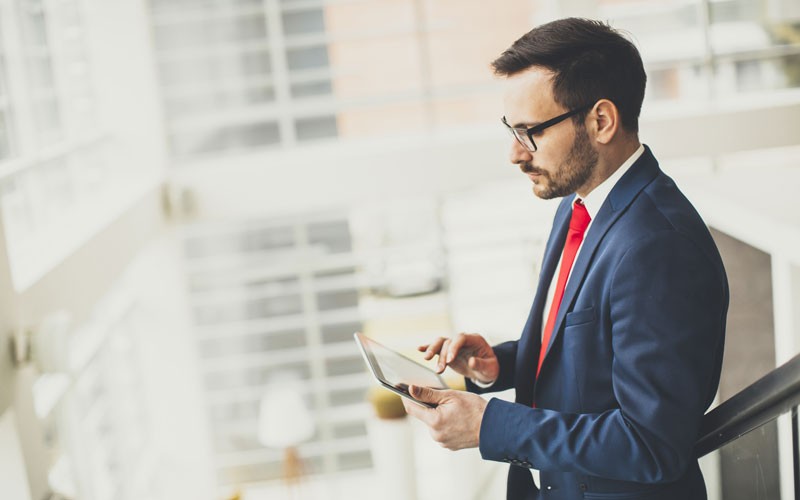 FireEye email security in real-time Business man walking through building using tablet device