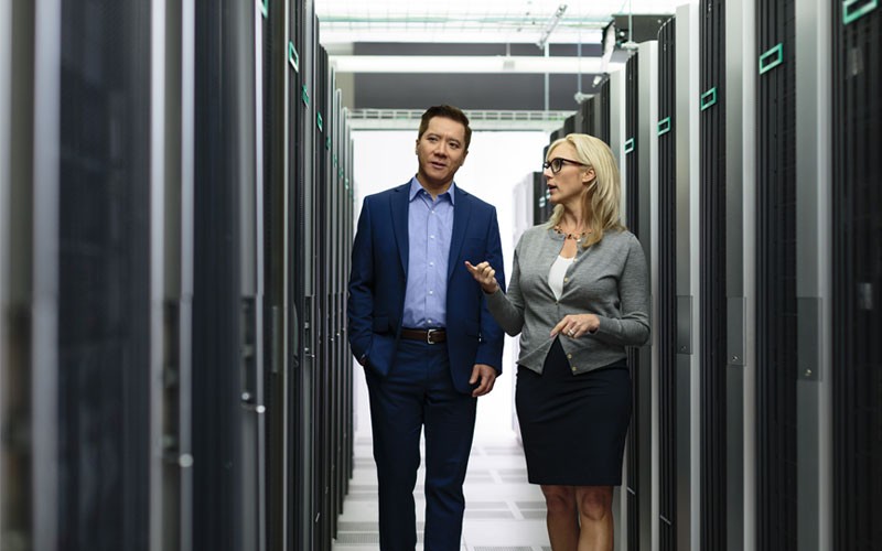 Two employees walking through server room