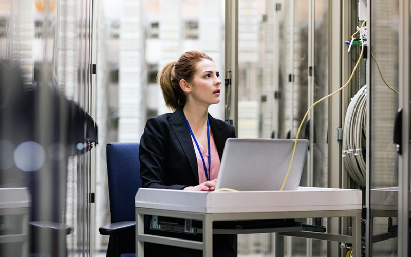 Keep your data secure and your performance uncompromised IT technician surveying servers in data center