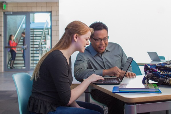 Teacher helping student out with assignment