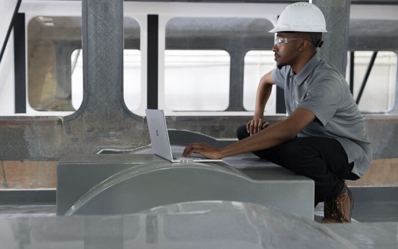 Des outils optimisés pour votre industrie Ingénieur travaillant avec une Microsoft Surface sur le terrain