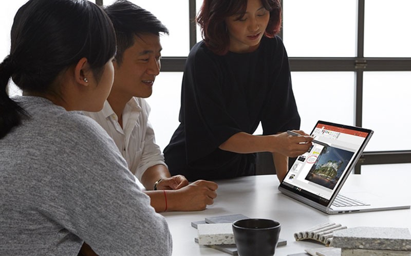 Microsoft Office Teammates working together using Microsoft Office PowerPoint on Surface device