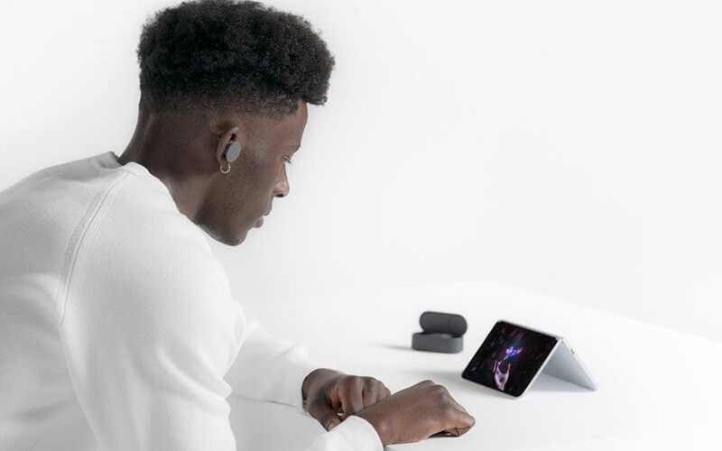 Collaborate seamlessly and work faster when on video calls with the Surface Duo Male watching on Surface duo