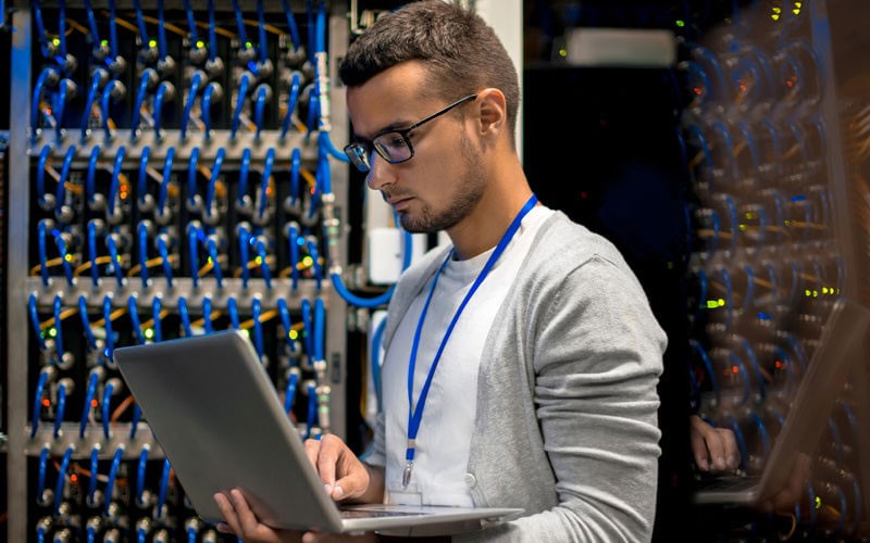 man-looking-at-laptop-surrounded-by-storage-left man-looking-at-laptop-surrounded-by-storage-left