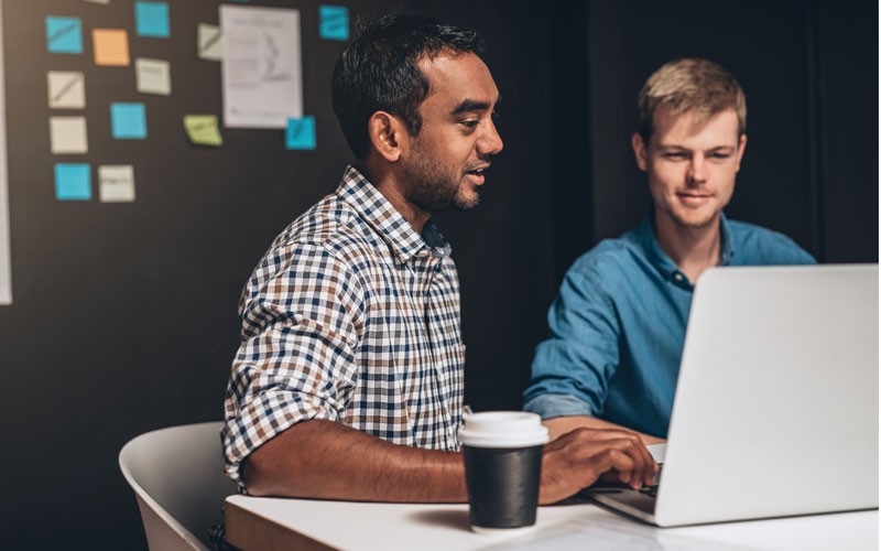 Two male employees collaborating Nutanix supports all software-defined storage services