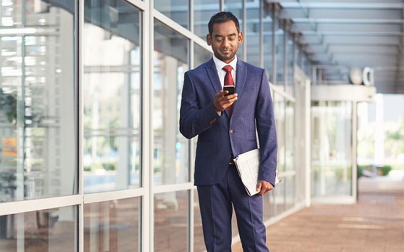 Nutanix Prism for centralized cloud management Business man using mobile device outside