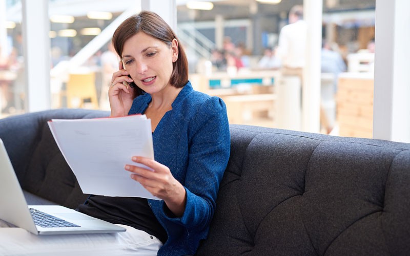 Deploy and manage your business with Nutanix VDI solutions Woman reading in office using laptop
