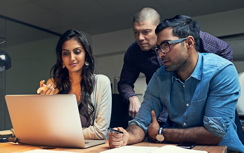 Three employees collaborating